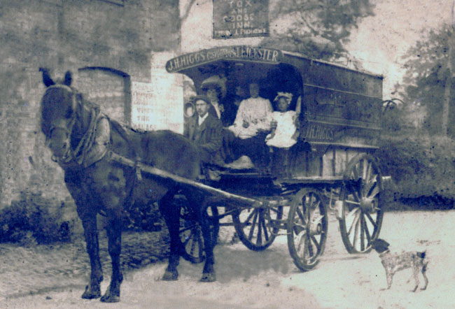 A horse drawn wagon signwritten with J.H.Higgs.