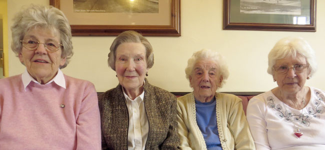 Four female parish councillors sit in a line.