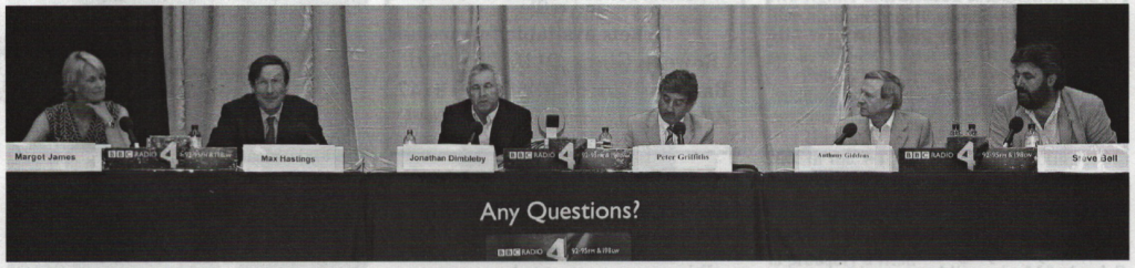 Six people seated behind a table during a BBC Radio 4 Any Questions? broadcast, with microphones and name cards.